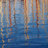 Reflections of sailboat masts in the water in the Barcelona harbour
