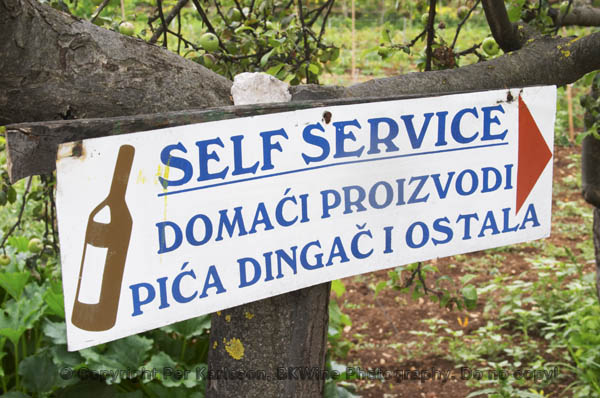 A sign at a winery pointing the way to Self Service shopping