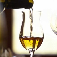 A glass of wine filled with Moscato de Pantelleria in a restaurant on Sicily, Italy