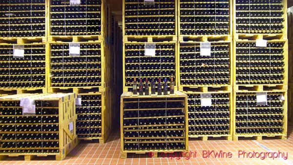 Wine bottles in storage in boxes in a wine cellar